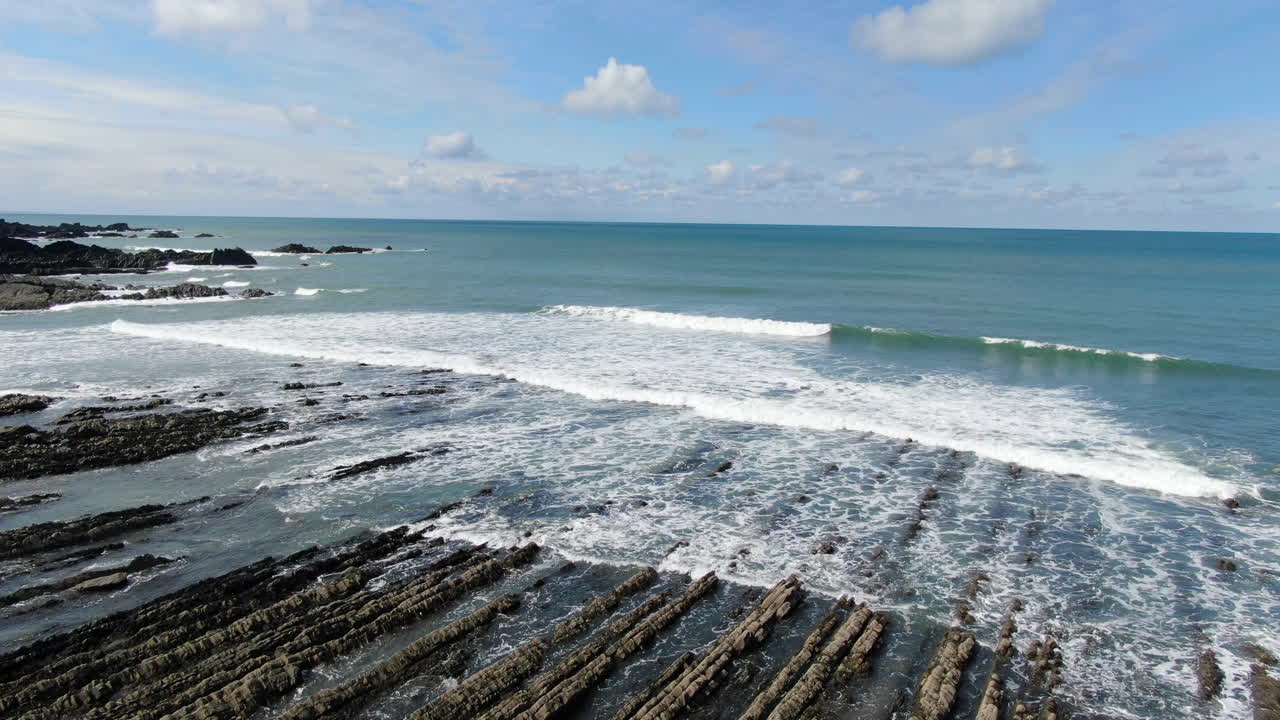 Imagem aérea costeira das ondas no mar na praia de Spekes Mill em Devon, Inglaterra, Reino Unido.