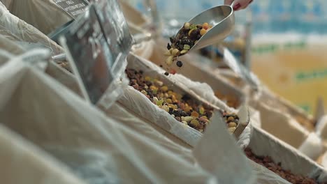 young girl pours dried fruit into a package