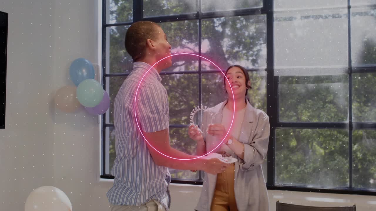Man using tablet in office neon rings swirling as woman bringing cake offering crown honoring peer