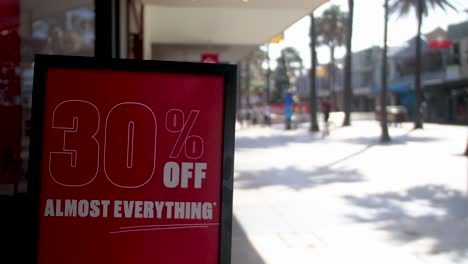 30% off shopping deal offer black friday retail sign on the street with pedestrians in 4k