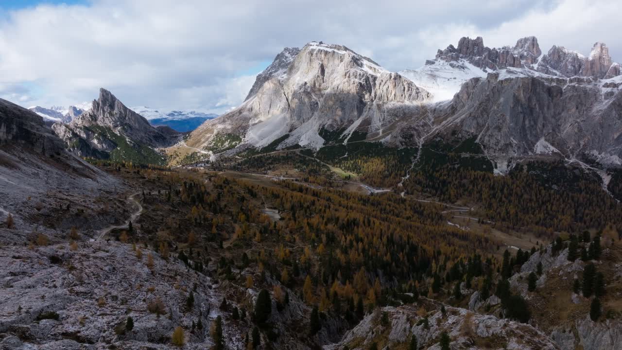 Drone clip as the Falzarego pass winds through the valley which is covered with autumn coloured tress