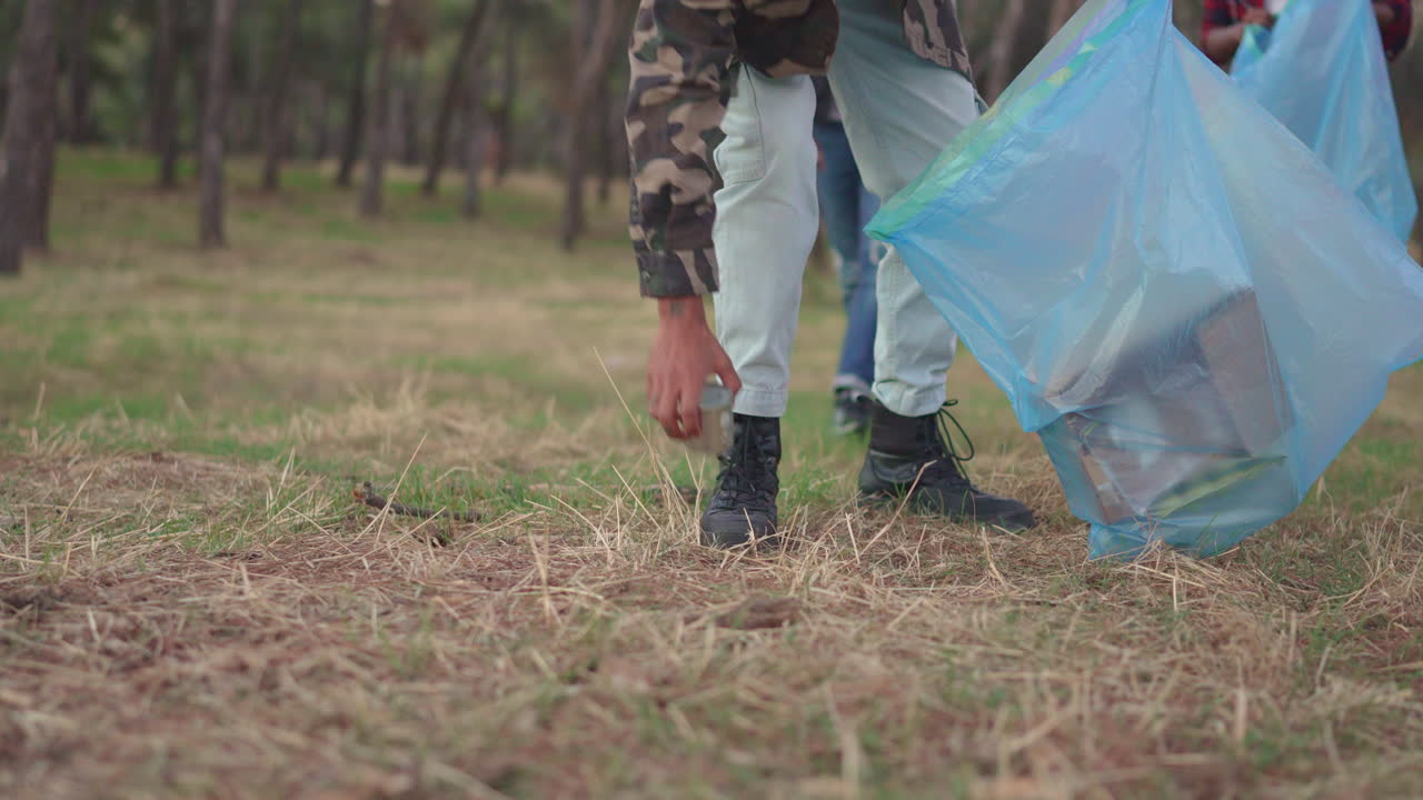 People cleaning up trash in a forest