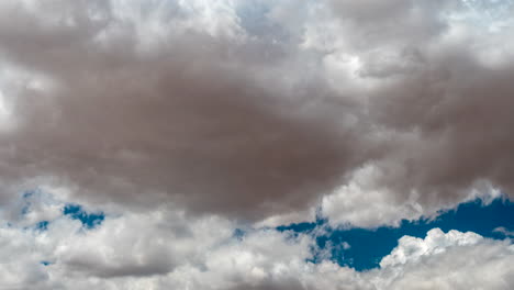 cumulus clouds create abstract formations against the blue sky - time lapse