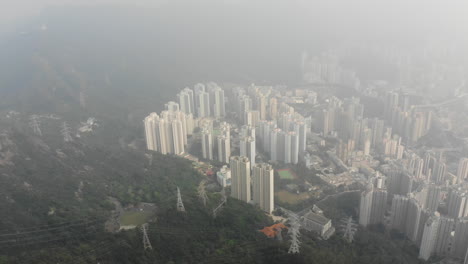 Aerial-drone-shot-of-Tsz-Wan-Shan-and-Sha-Tin-from-Lion-Rock-in-Hong-Kong-on-a-foggy-day-in-October