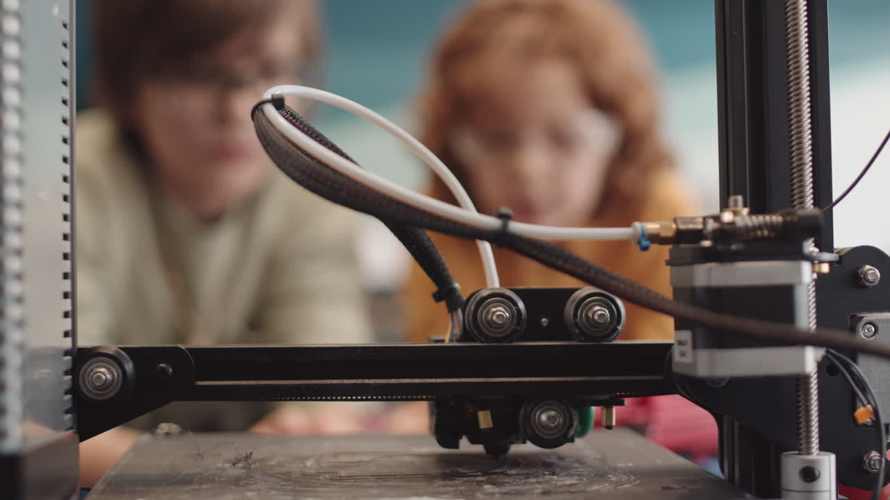 Three Unrecognizable Pupils Watching 3D Printer Working