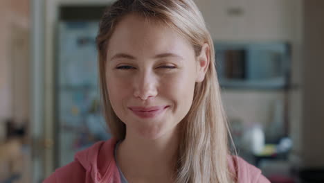 portrait beautiful blonde teenage girl in kitchen at home smiling happy enjoying carefree lifestyle