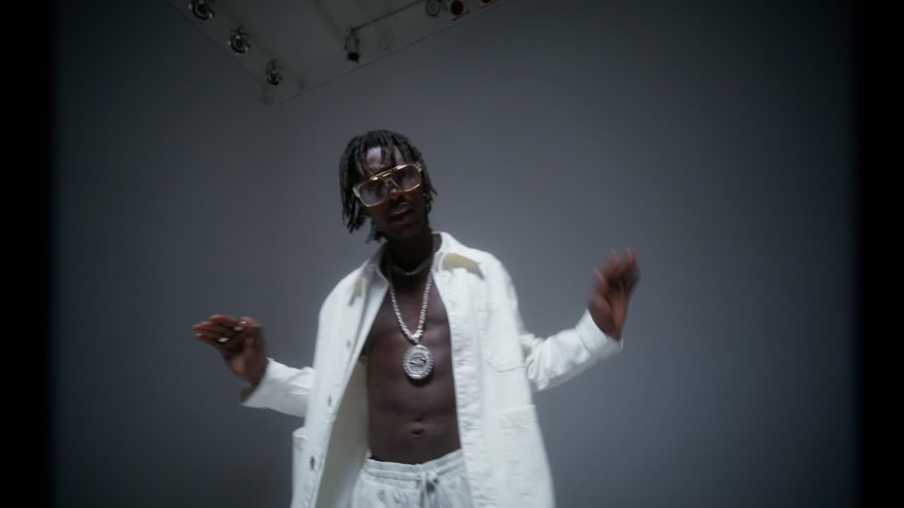 Stylish Man in White Outfit Posing in Studio
