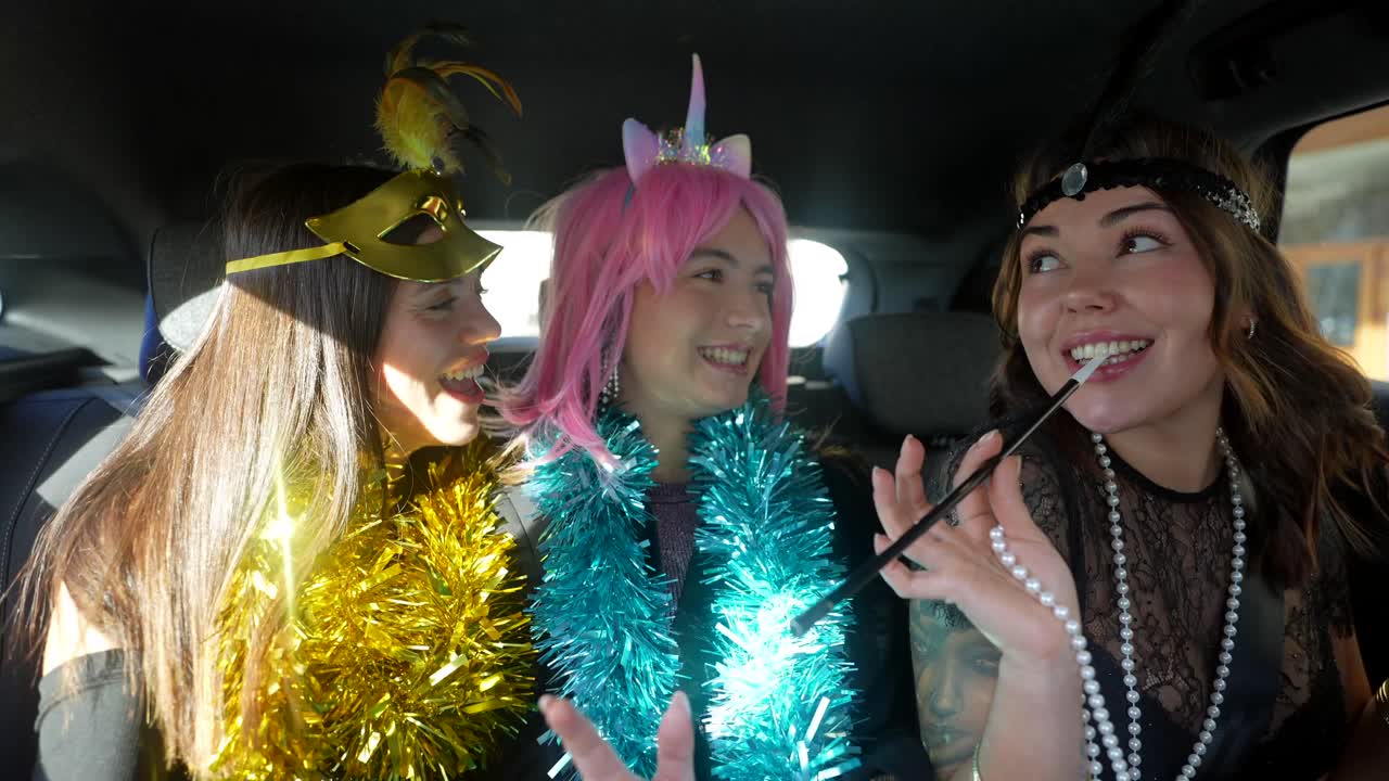Women in costumes having fun in a car