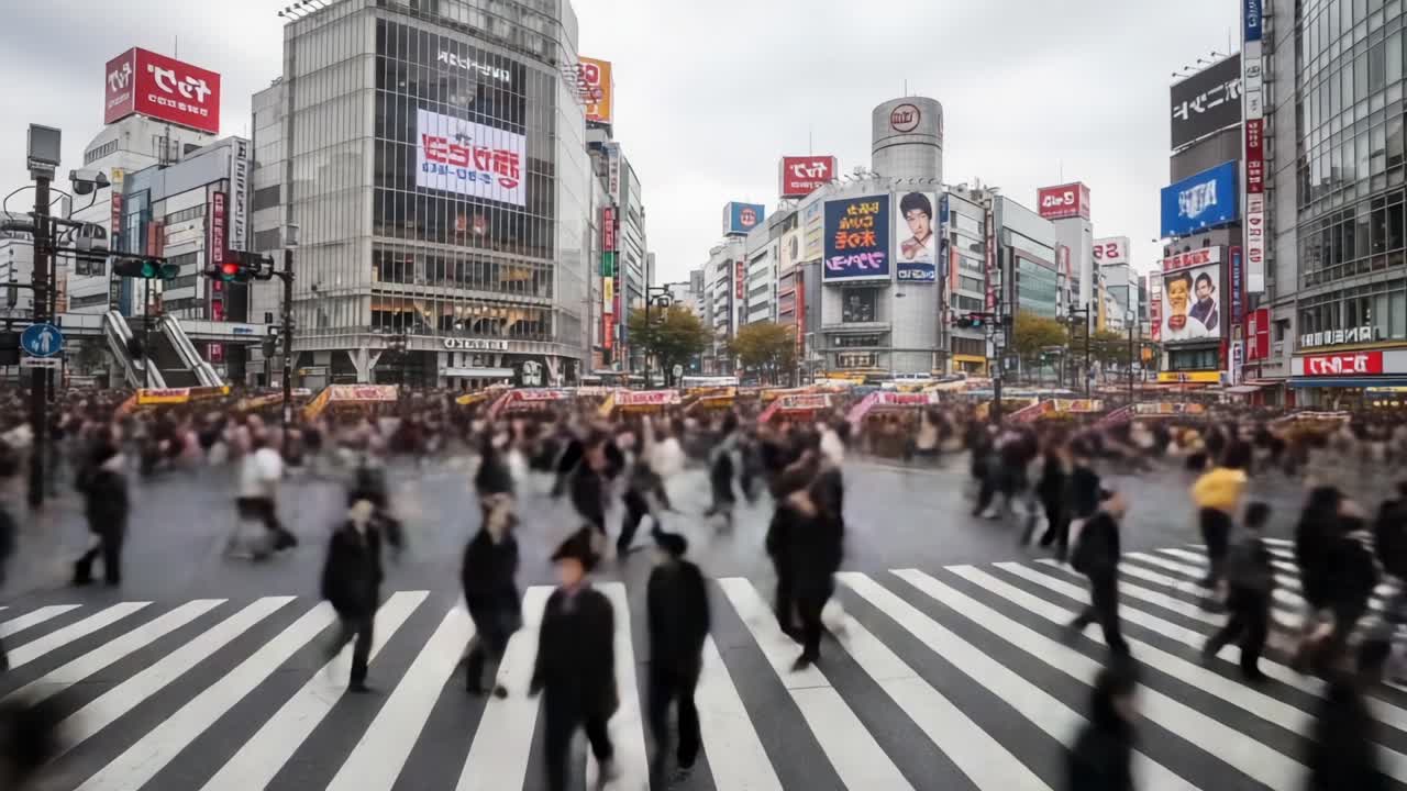 A Bustling Urban Crosswalk Captured in Motion: A Sea of People Navigating an Iconic Intersection with Vibrant Advertisements Amidst a Grey Cityscape
