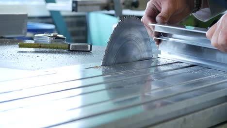 circular saw cutting through stainless steel in a metal factory