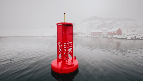 red buoy in a foggy fjord