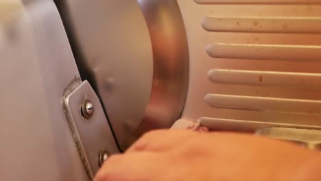 hand slice raw meat with slicer, close up