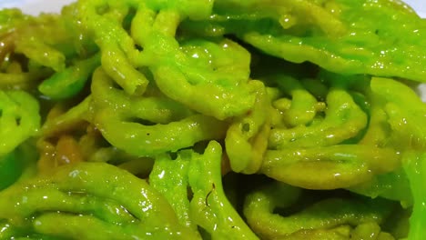 crispy sweet asian dessert green jalebi cooked and served in festivals.