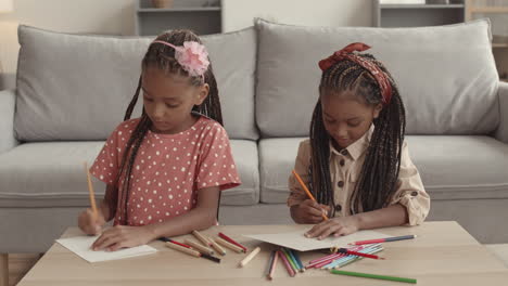 two little african girls drawing
