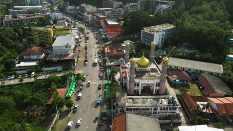 aerial view of mosque and traffic in ao nang during sunny day, thailand - ocean in background