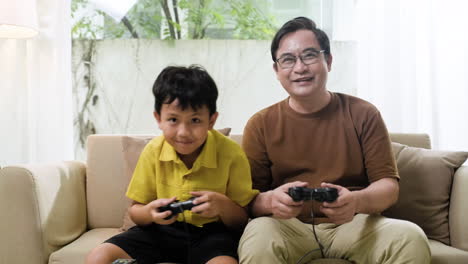 asian man and boy in the living room