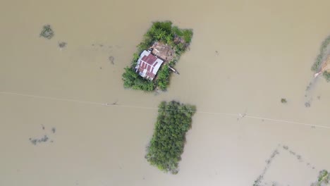 aerial view of submerged homes in a flooded rural bangladesh village
