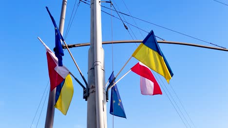 flags of ukraine, poland and european union. flags as symbol of support for ukraine after russian invasion.