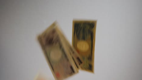 Shot-of-few-bank-notes-falling-across-the