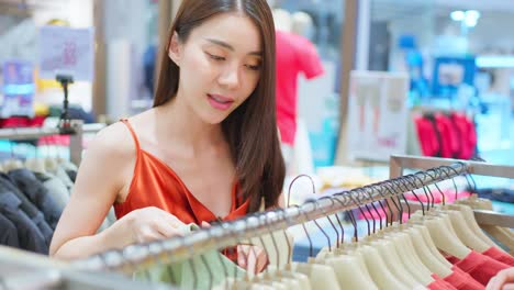 woman shopping for clothes in a clothing store