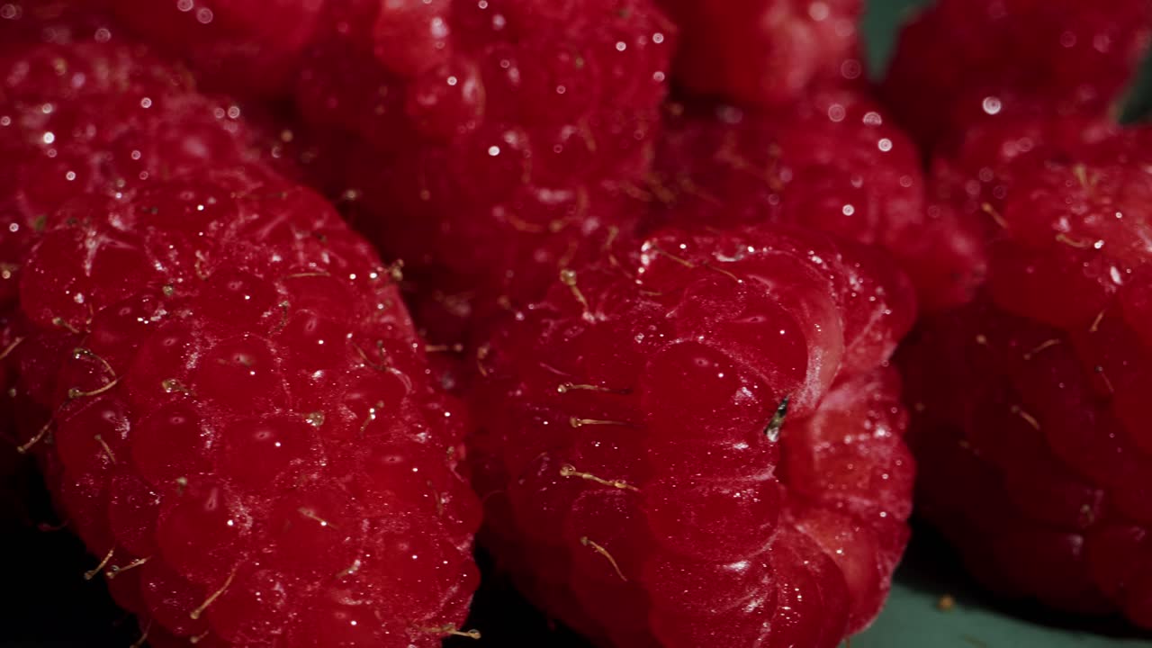 A closeup view of fresh, ripe raspberries, highlighting their vibrant color and delightful texture