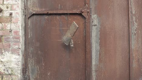 old rusty metal door slams shut