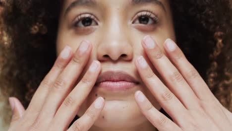 Biracial-woman-with-dark-hair-touching-face,-slow-motion