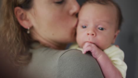 Video-of-caucasian-mother-kissing-and-hugging-newborn-baby
