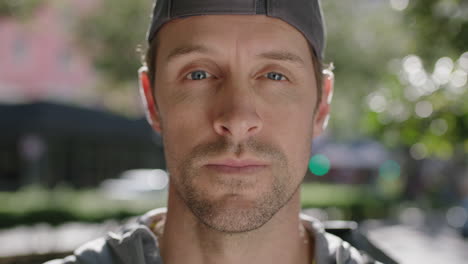 close up portrait of attractive fit young man wearing breathing looking pensive on city street