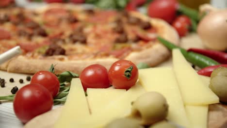 italian pizza surrounded by fresh foods