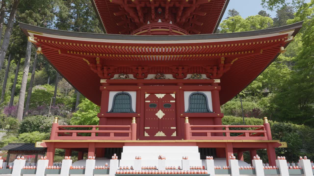 Red pagoda in nature on a sunny day in Katsuoji Temple, Osaka, Japan