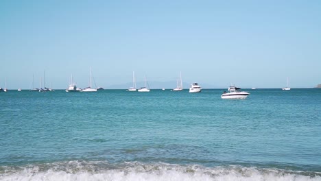 panning shot of yachts and sailboats in bay on waiheke island, new zealand