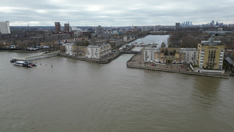 panning drone aerial surrey quays riverside apartments on river thames south london uk