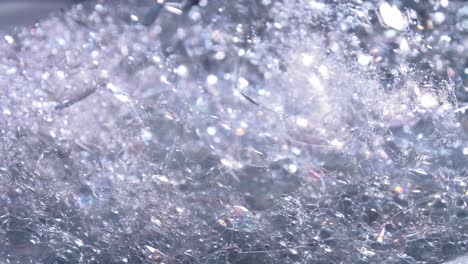 transparent foam bubbles movement and bursting in white bowl