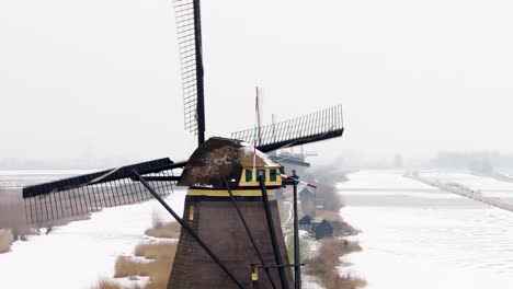 iconic dutch windmills in snowy landscape, kinderdijk, netherlands