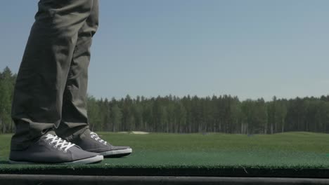 person standing on a golf driving range