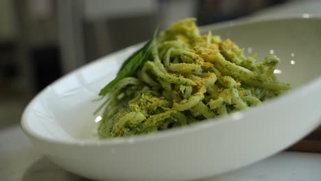 zucchini pasta on a bowl in kitchen.