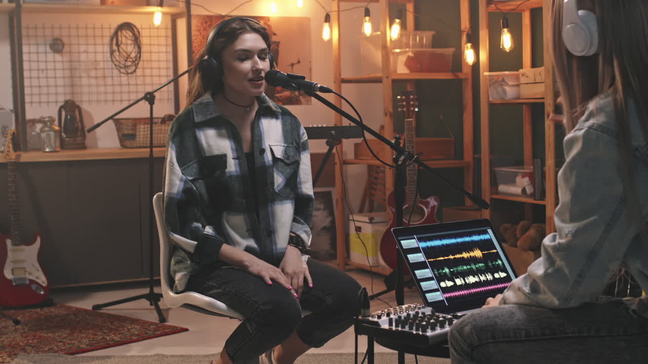 Young Woman Recording Song In Studio