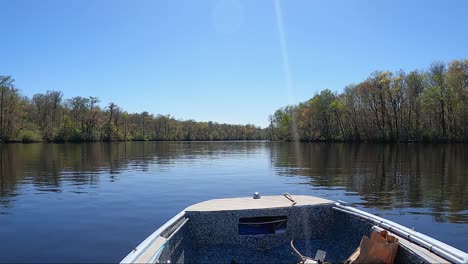 pov of riding on a calm river on a sunny autumn day in a motorized boat on edisto river, south carolina