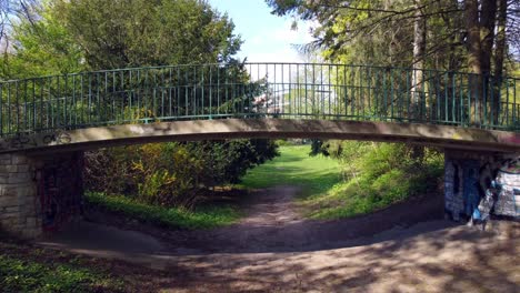 between trees along a path down through footbridge