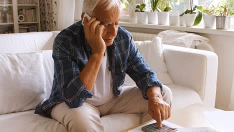 tensed senior man talking on mobile phone