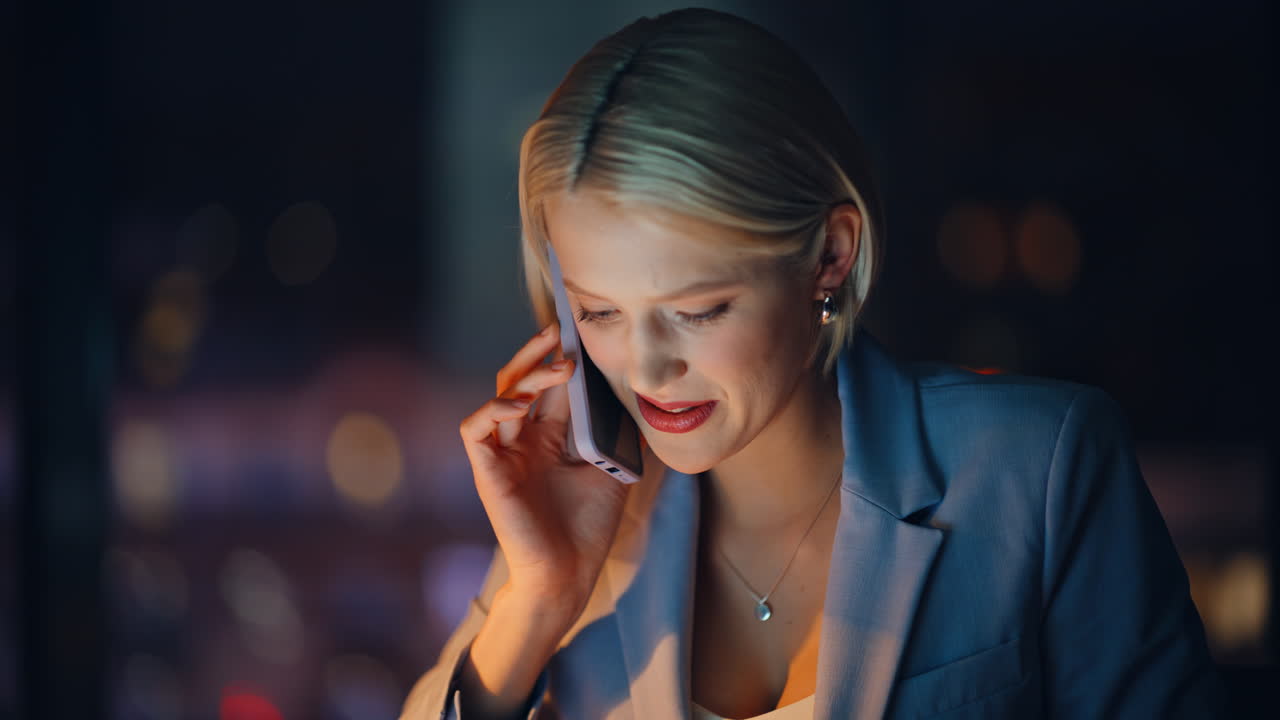 Laptop worker calling mobile phone in evening office closeup. Smiling executive