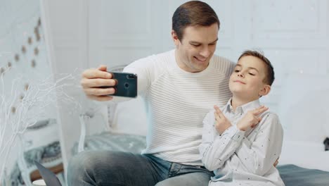 Lächelnder-Vater-Und-Sohn-Machen-Gemeinsam-Ein-Selfie-Im-Luxushaus.