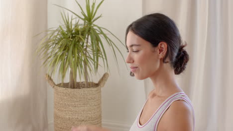 young woman practicing yoga at home, meditating with hands in prayer position