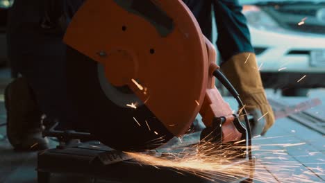 professional mechanic is cutting steel metal.