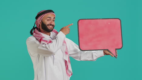 muslim adult holds speech bubble