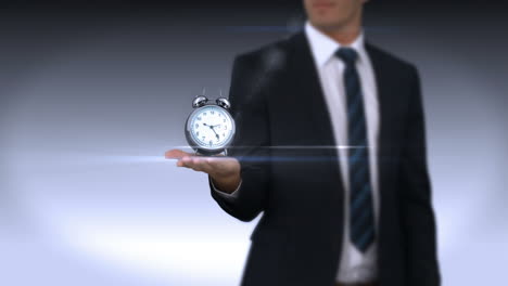 hand of businessman holding alarm clock