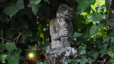 candle next to gnawing gargoyle in carmel patio