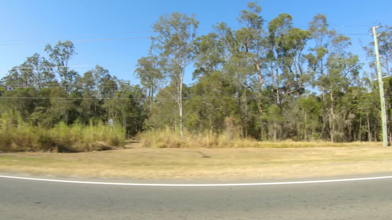 Right facing driving point of view POV of quiet Australian country roads - ideal for interior car scene green screen replacement