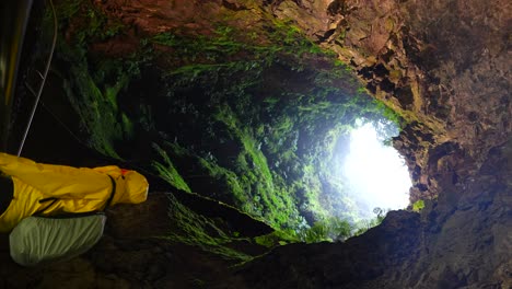 tomada vertical de un hombre dentro del tubo volcánico de algar do carvao en las azores, estática